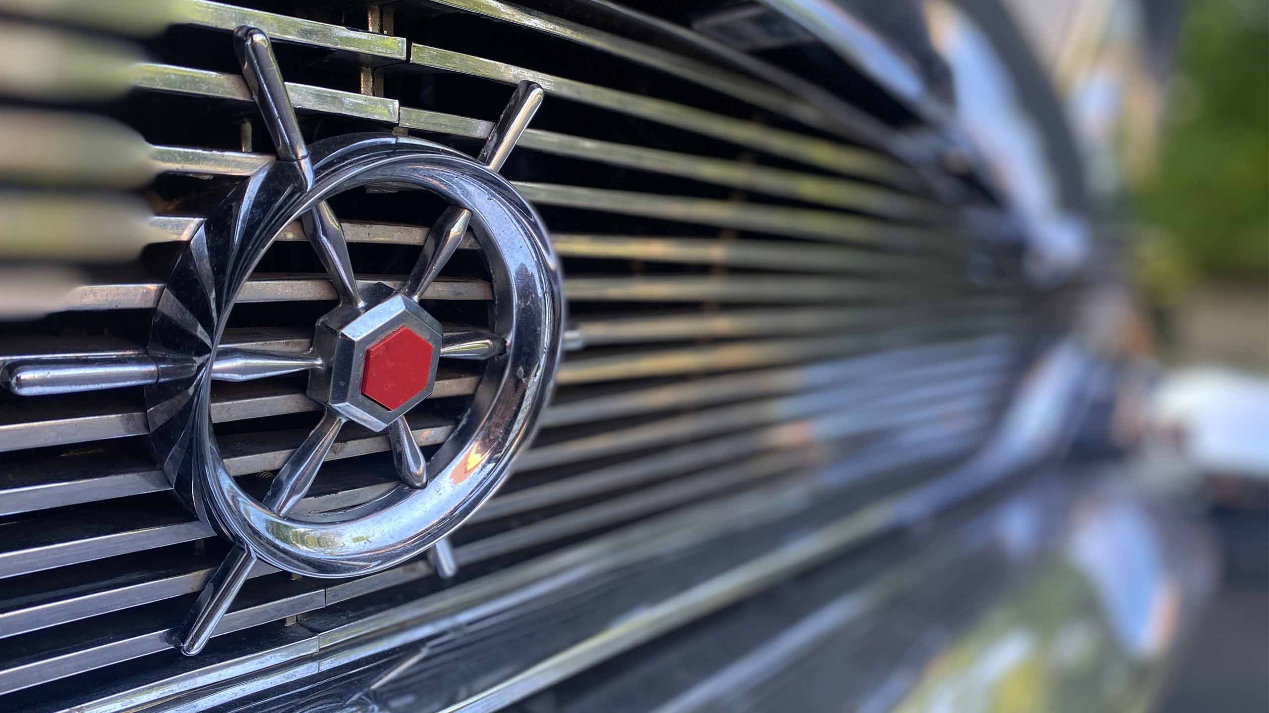 1956 Packard Clipper Custom, ship's-wheel grille emblem in close focus